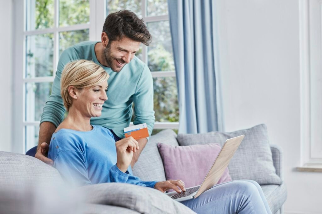 Happy couple at home shopping online